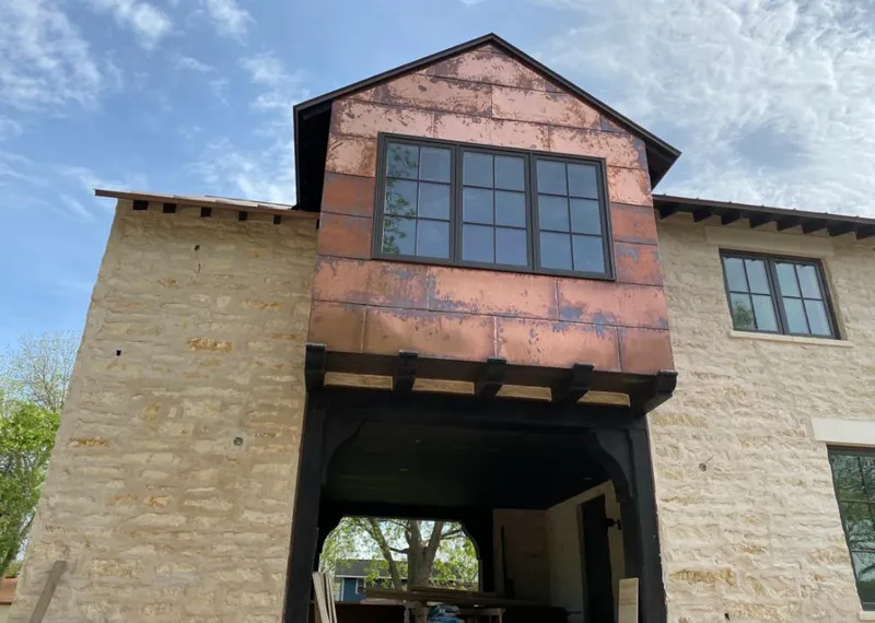 Copper metal panel facade on a stone building for Roof Repair in Gladeview